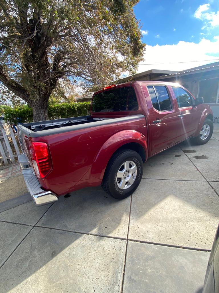 Red pickup truck with tinted cab windows parked at a home