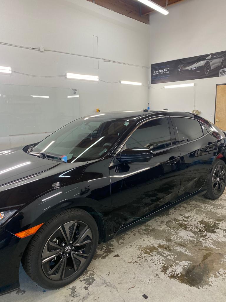 Black Honda Civic with fresh ceramic tint inside the shop