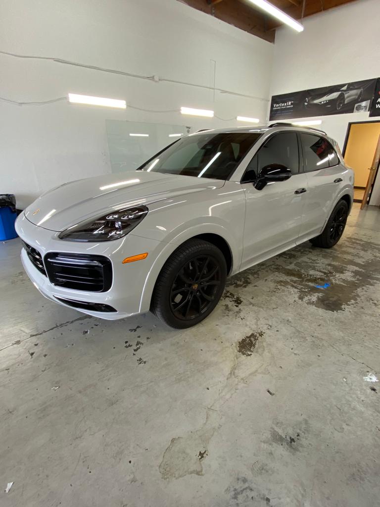White Porsche Cayenne with dark ceramic tint on all side windows