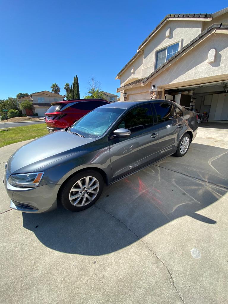 Gray sedan with freshly tinted windows on a customer's driveway
