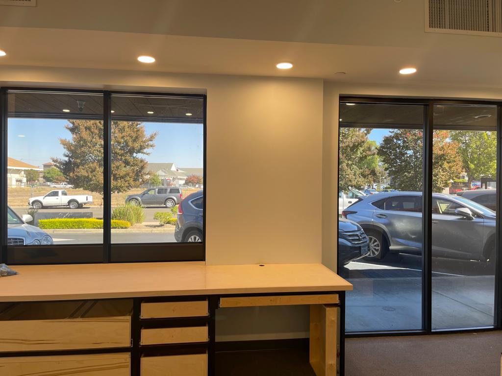 Retail interior with tinted windows facing a parking lot