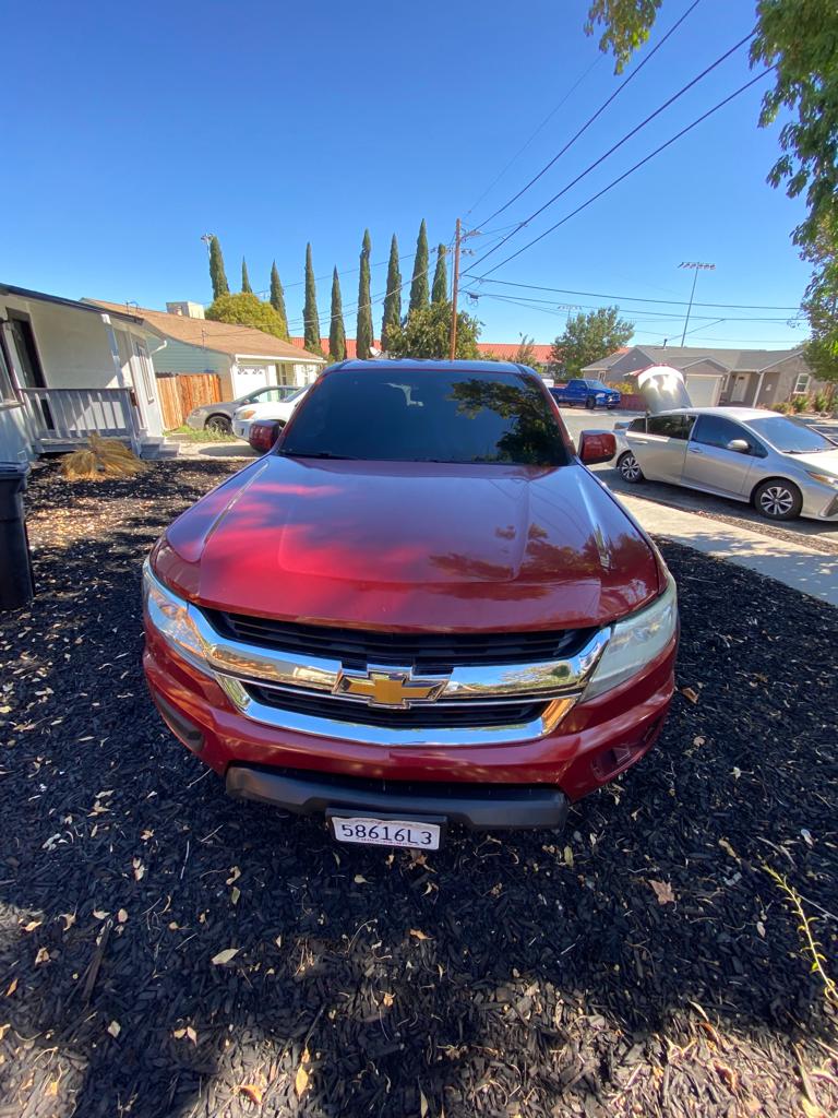 Red Chevrolet SUV with a dark tinted windshield and front glass