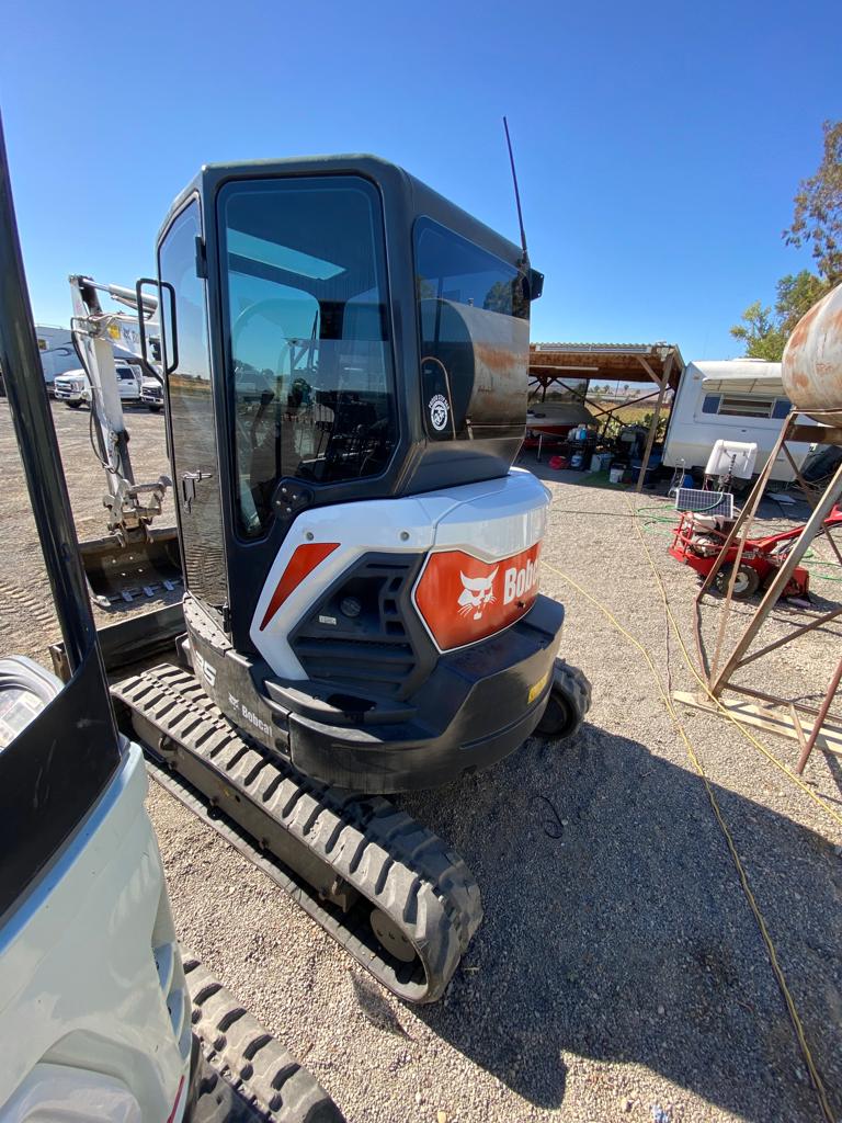 Bobcat mini excavator with tinted cab glass in a Delta equipment yard