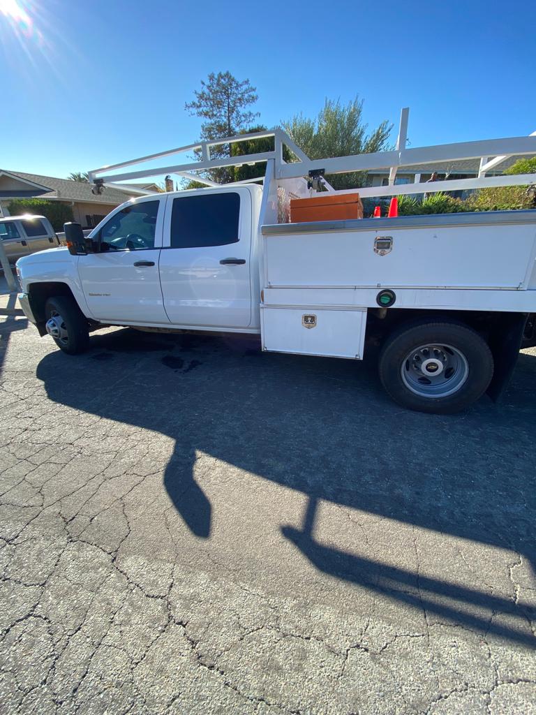White Chevrolet utility bed work truck with tinted cab windows